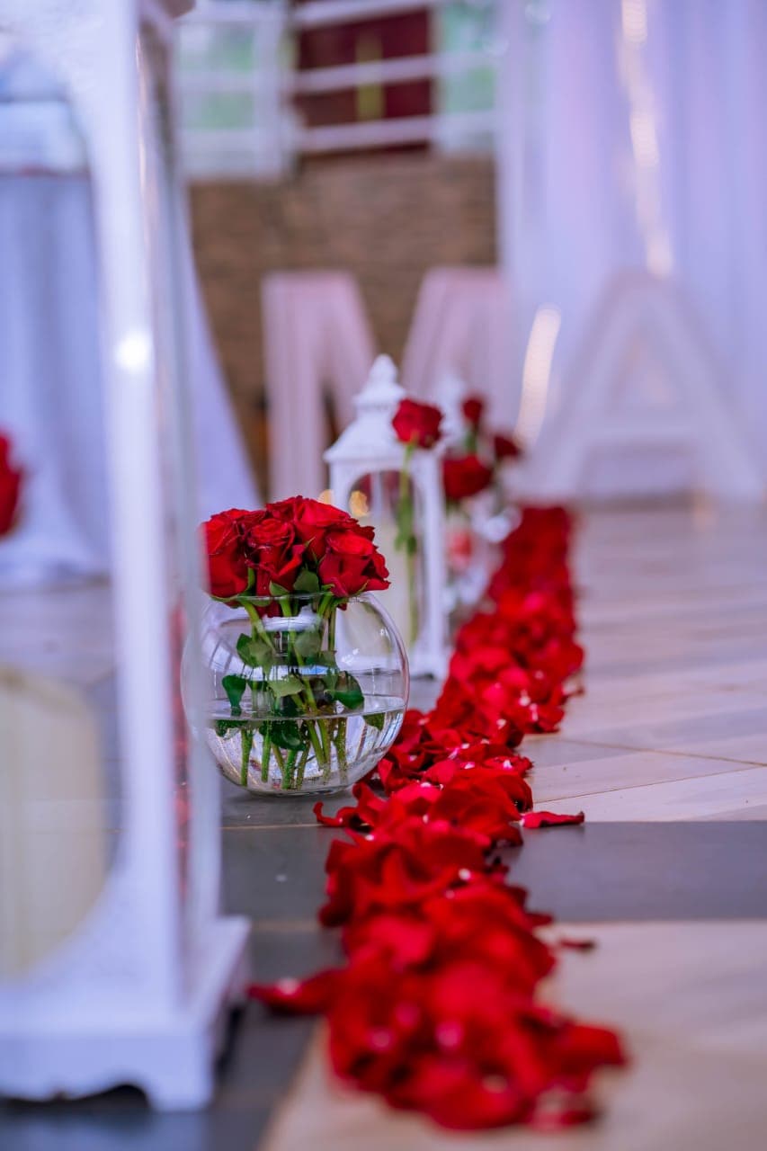 Red roses and lanterns lining a walkway