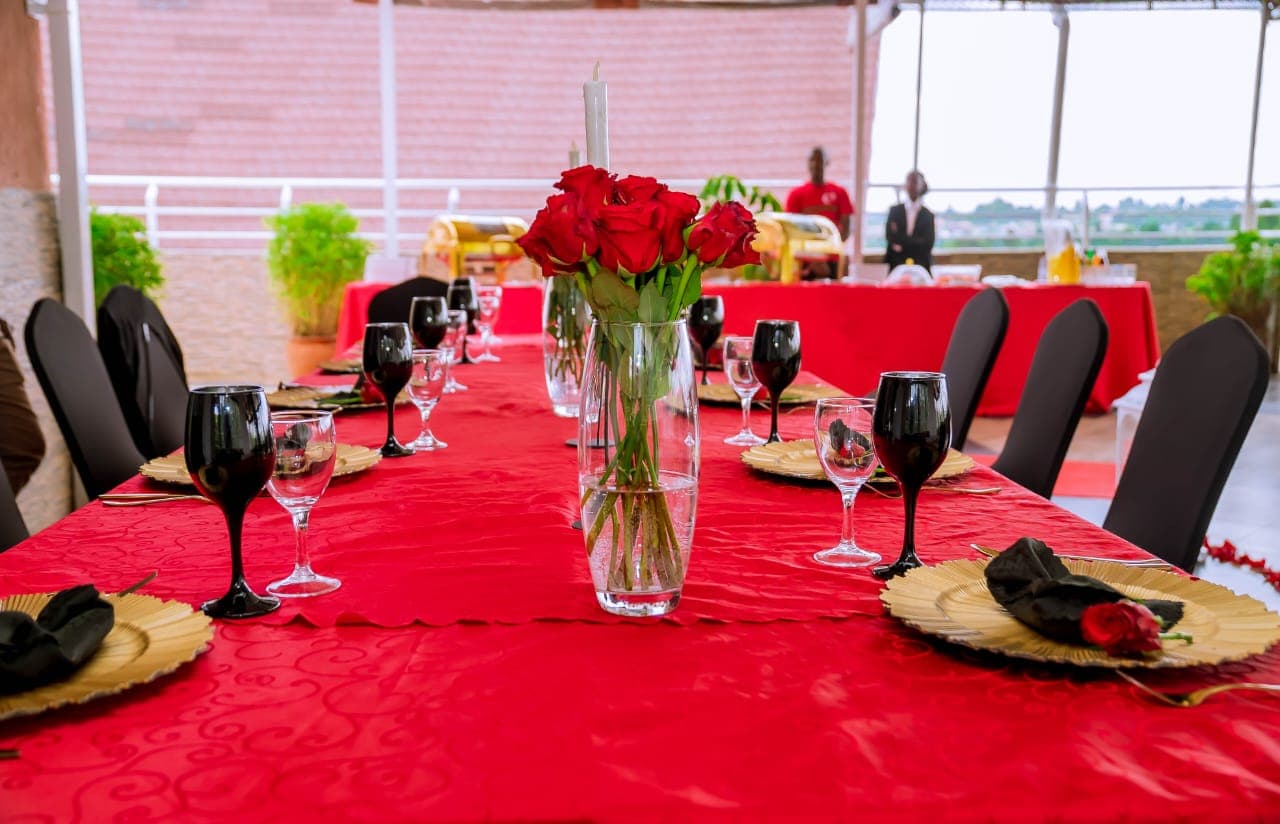 A red table setting with roses